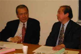 Dr. Thomas Tam listened intently to Prof. Jin's talk to prepare for its translation to the audience.